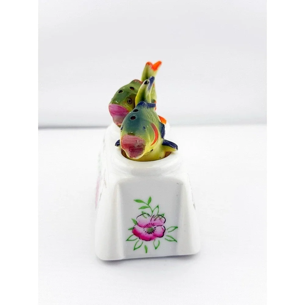 Vintage Japanese porcelain nodder fish salt & pepper shakers with a floral base